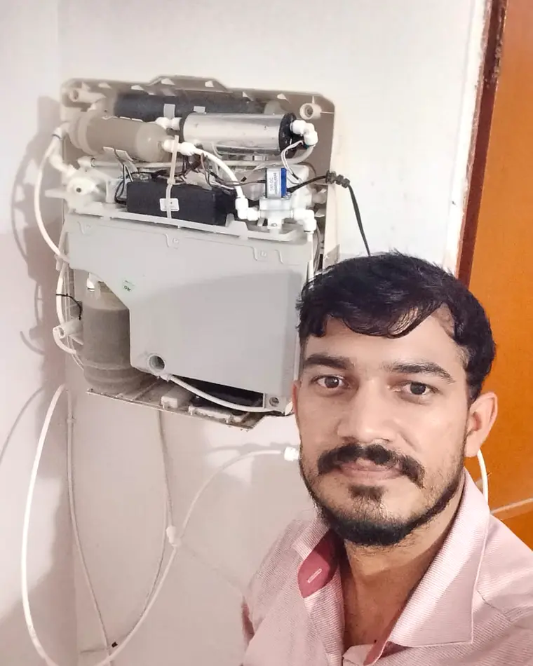 Local Aarohi RO technician beside an opened purifier during service